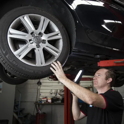 Car suspension service being performed
