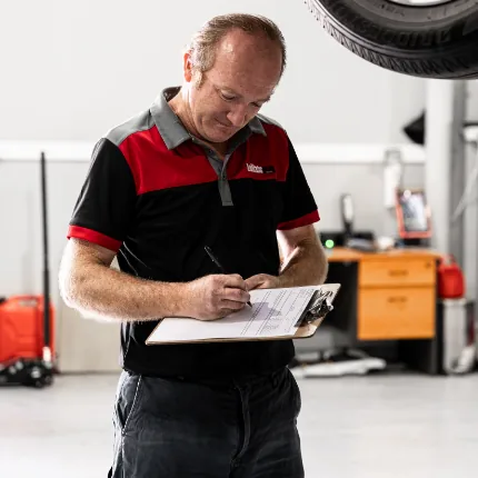 Car safety certificate being issued at mechanic