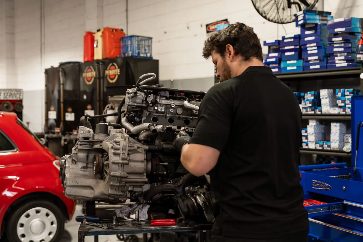 Bosch Service Brisbane mechanic working on an engine and gearbox removed for a clutch replacement