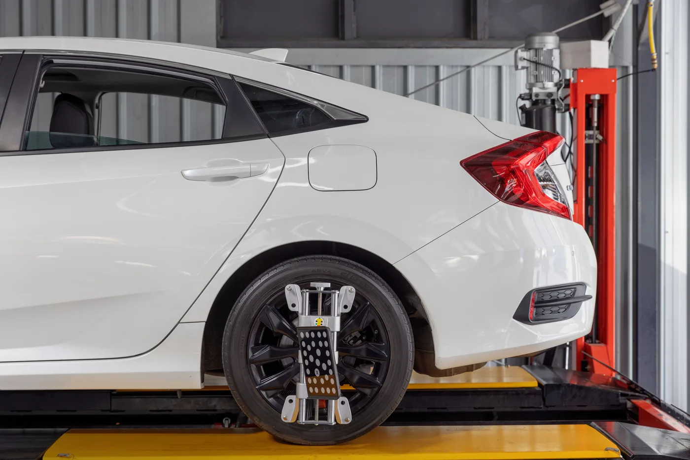 Precision alignment target clamped to a wheel on the alignment ramp at Bosch Service Brisbane